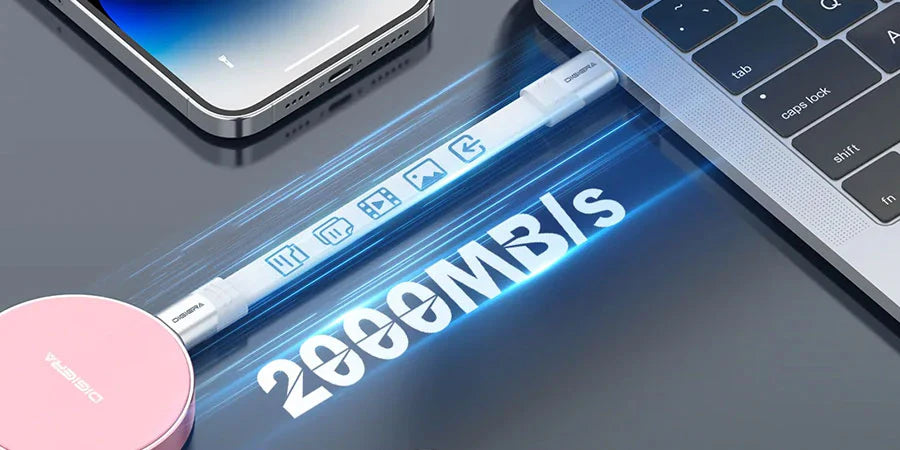 Portable external hard drives connected to a MacBook on a desk setup.